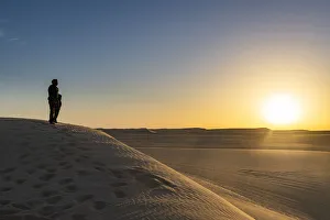 Tuareg Prints: Tuareg standing on a sand dune in the Tenere Desert at sunrise, Sahara, Niger, Africa