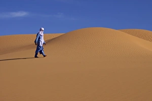 Tuareg Prints: A Tuareg walking on a dune of the erg of Uan Kaza in the Fezzan desert