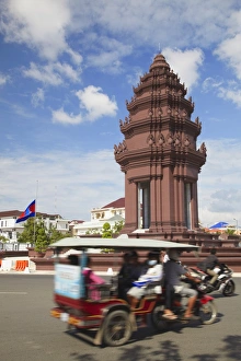 Cabs Prints: Tuk tuk passing Independence Monument