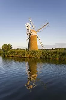 Turf Fen windmill reflected in the River Ant at sunrise, Norfolk Broads