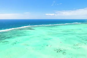 Mauritius Prints: Turquoise coral reef meeting the blue Indian Ocean, aerial view by drone, Ile Aux Cerfs