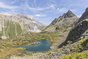 Albula Pass Prints: Turquoise lake between rocky peaks and meadows