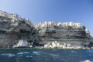Cliff Top Prints: The turquoise sea frames the ancient village perched on the white cliffs, Bonifacio