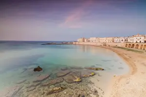 Gallipoli Prints: Turquoise sea frames the beach and the medieval old town at sunset Gallipoli