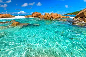 Turquoise sea of natural pool, clear calm waters of swimming pools at Anse Cocos near