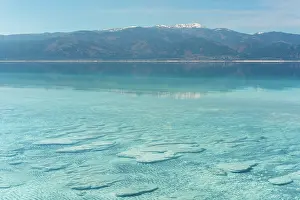 Geotourism Prints: Turquoise waters of Salda lake showcase stromatolites under a bright sky in Turkey