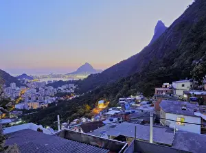 Favela Prints: Twilight view of the Favela Santa Marta with Corcovado and the Christ statue behind