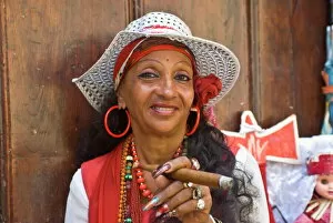 Typical dressed Cuban woman smoking a giant cigar, Havana, Cuba, West Indies