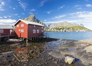 Moskenesoya Prints: Typical house of fishermen called Rorbu reflected in blue sea, Reine, Moskenesoya