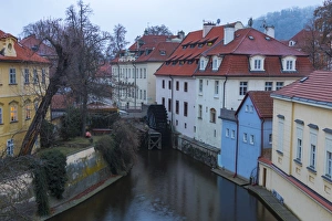 Typical houses on water canal frame the old mill of Certovka, Lesser Quarter, Prague