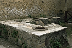 Herculaneum Prints: Typical shop with large storage vessels