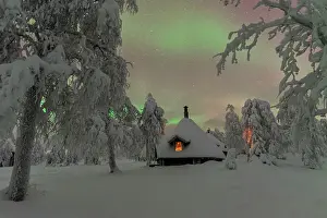 Muonio Prints: Typical wooden illuminated hut under the Northern Lights (Aurora Borealis)