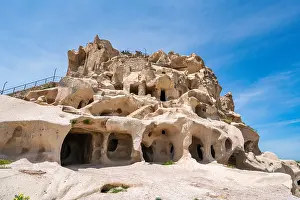 Cappadocia Prints: Uchisar town castle shows caves within rock formation in Cappadocia Turkey during bright daylight