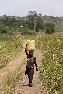 Uganda Prints: Ugandan child fetching water, Masindi, Uganda, Africa