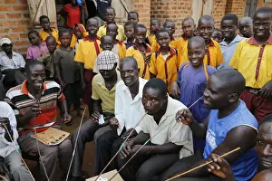 Uganda Prints: Ugandan villagers drinking home-brewed beer and schoolchildren, Bweyale, Uganda, Africa
