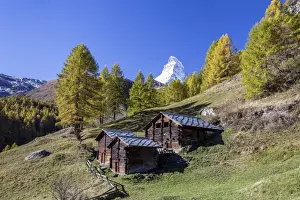 The unique shape of the Matterhorn seen from a little group of mountain huts by Zermatt, Swiss Canton of Valais, Swiss Alps, Switzerland, Europe