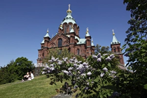 Images Dated 11th June 2009: Uspenski Cathedral and girls sitting on hillside, Helsinki, Finland, Scandinavia, Europe