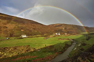 Rainbow Prints: A valley rainbow forms in the face of an autumn squall