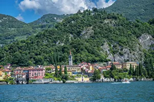 Homes Prints: Varenna offers a view of colorful buildings near Lake Como with hills in the background