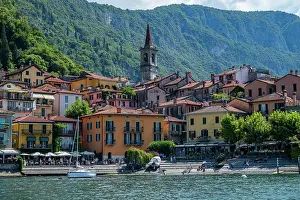 Varenna Prints: Varenna shows colorful buildings along the shoreline of Lake Como under a bright sky with mountains in the background