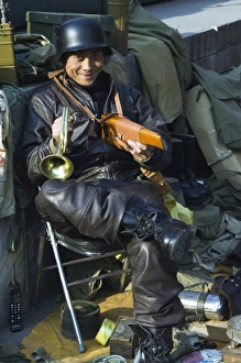 Uniforms Prints: A vendor selling war memorabilia, Baoguo Temple antiques market, Beijing, China, Asia
