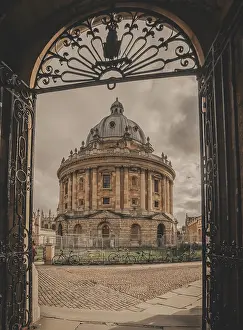 Metal Prints: A vertical image of the Radcliffe Camera and Radcliffe Square framed by a metal gate in Oxford