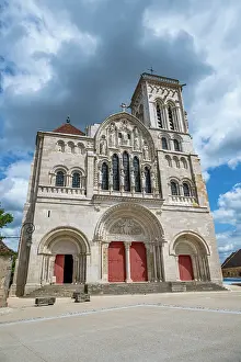 Large Prints: Vezelay Abbey features Romanesque architecture in the hill town of Vezelay in France with cloudy sky overhead