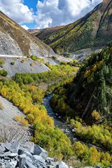 Season Prints: Vibrant autumn colors in the Caucasus mountains with flowing river near South Ossetia in Russia