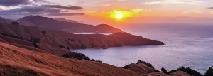 Zealand Prints: Vibrant sunset over rugged coastline and golden hills in Marlborough Sounds region of South Island New Zealand