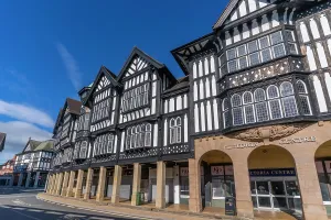 Windows Prints: Victorian architecture in Chesterfield during autumn with clear blue sky and historical buildings in the foreground