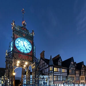 Time Collection: The Victorian Eastgate Clock on the city walls at night, Eastgate Street, Chester, Cheshire