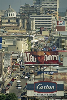 Bill Board Prints: View down 7 Avenida with advertising signs and buildings