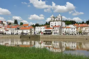 Alentejo Prints: View of Alcacer do Sal along the Sado River with white buildings and blue sky in Portugal during daytime hours