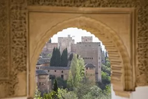 View to the Alhambra through arch in gardens of the Generalife, UNESCO World Heritage Site