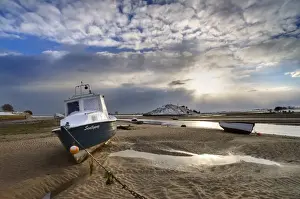 Tides Prints: View across Aln Estuary at low tide showing boat and distanyt fields covered in snow