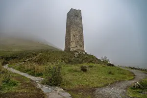 Season Prints: View of an ancient tower surrounded by fog in the Caucasus mountains of North Ossetia
