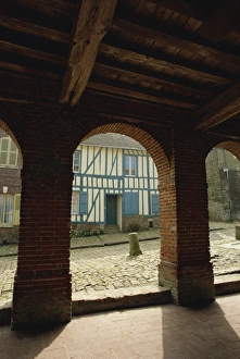 Picardie Prints: View through arch of colourful timbered house, Gerberoy, Oise, Picardie, France, Europe