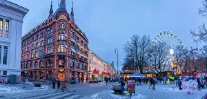 Friends Prints: View of architecture on Karl Johans Gate and Christmas market during winter at dusk