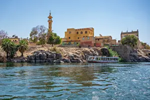 Nubia Prints: View of architecture on the Nile river from small boat in Aswan