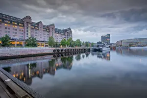 Aesthetics Prints: View of architecture reflecting in harbour on cloudy evening
