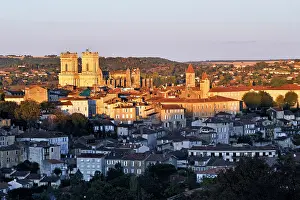 Warmth Prints: View of Auch in Gers department with historic buildings and houses during sunset in southwestern France
