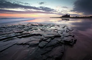 Dramatic Sky Gallery: View towards Bamburgh Castle at sunrise from Bamburgh Beach, Bamburgh, Northumberland