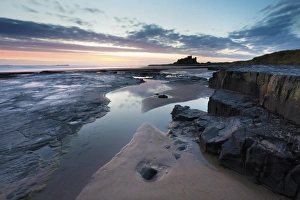 View towards Bamburgh Castle at sunrise from Bamburgh Beach, Bamburgh, Northumberland