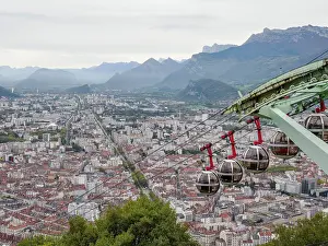 Auvergne Rhone Alpes Prints: View from the Bastille hill over Grenoble with mountains in the background and cable car in the foreground