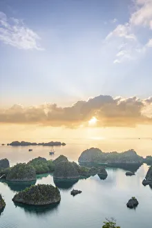 Sunbeam Prints: View over a bay of islands at dawn from the Piaynemo lookout, Raja Ampat, West Papua