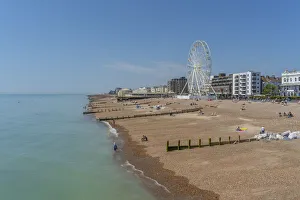 Ferris Wheel Prints: View of beach front houses and ferris wheel from the pier, Worthing, West Sussex, England