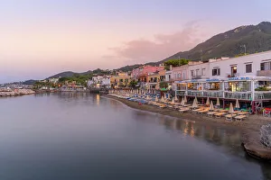 Relax Prints: View of beach and the town of Lacco Ameno at sunset