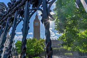 Fence Prints: View of Big Ben clock tower surrounded by trees and sunlight in Parliament Square during summer in Westminster