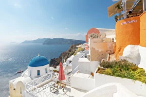 Traditionally Greek Gallery: View of blue domed church from cafe in Oia village, Santorini, Aegean Island, Cyclades Island