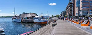 Waterfront Dining Prints: View of boat and sun loungers at the waterfront